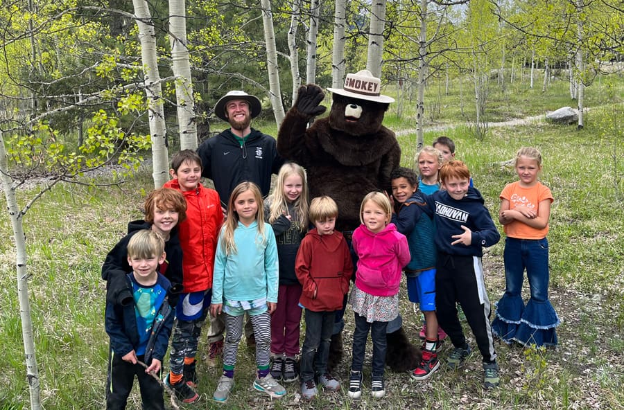 Garna Greater Arkansas River Nature Association - Education, stewardship, volunteering Salida - Smokey the bear with youth group