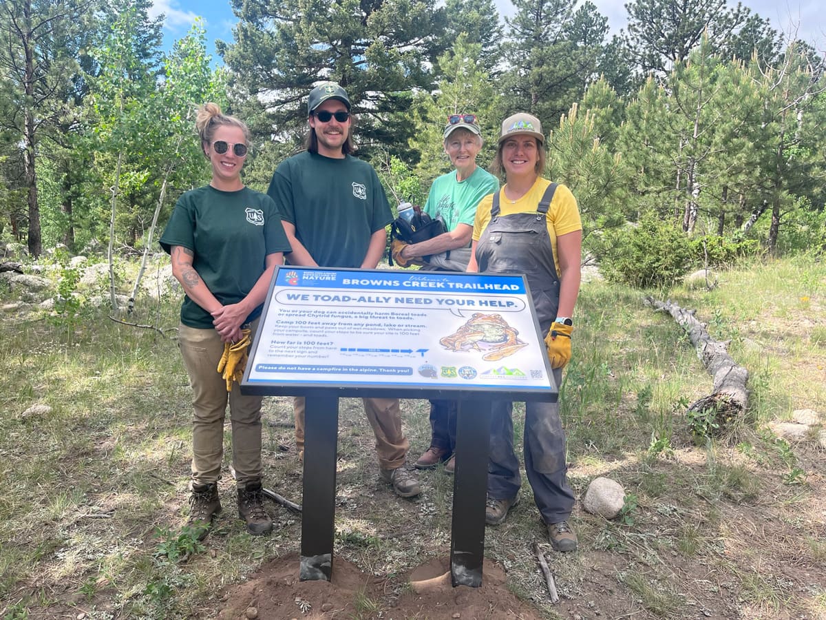 Friends of Fourmile group standing at trailhead sign